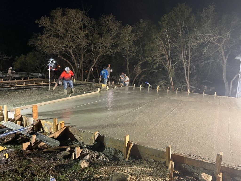 Metal building slab poured at night, San Antonio area